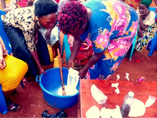 Women and girls learning how to make liquid soap